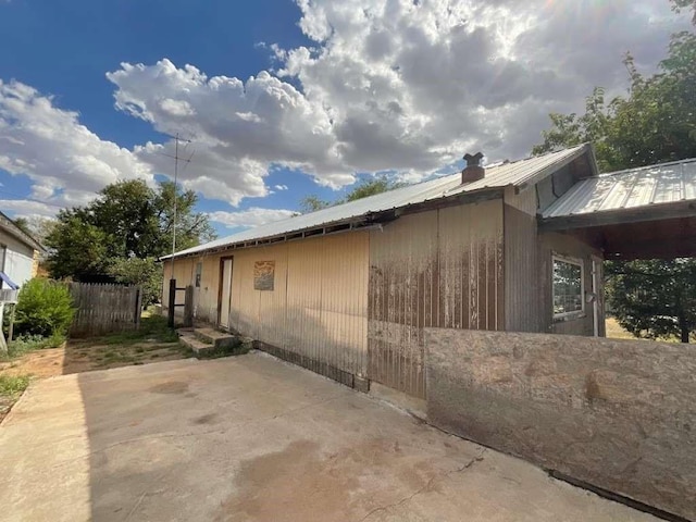 view of side of property with a patio