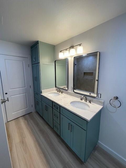 bathroom with vanity and hardwood / wood-style flooring