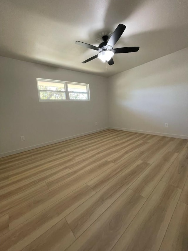 unfurnished room featuring ceiling fan and light wood-type flooring