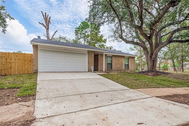 ranch-style house featuring a garage and a front lawn