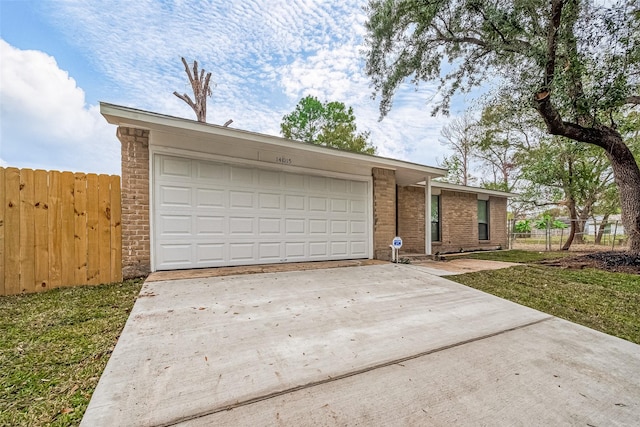 ranch-style home with a front yard and a garage