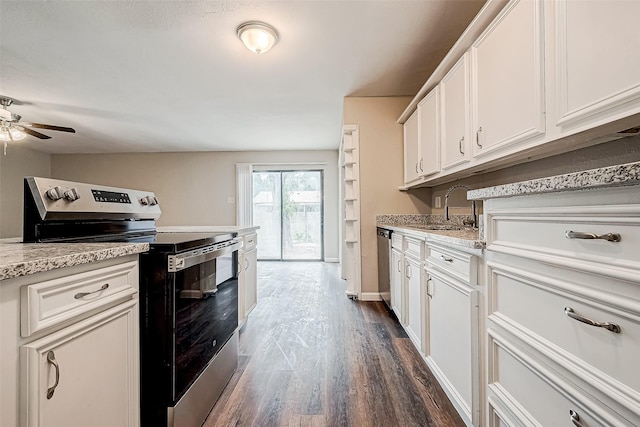 kitchen featuring white cabinetry, sink, dark wood-type flooring, stainless steel appliances, and light stone counters