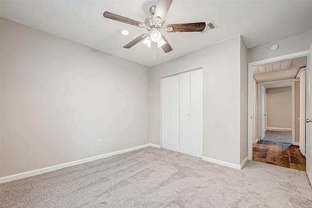 unfurnished bedroom featuring ceiling fan, a closet, and light colored carpet