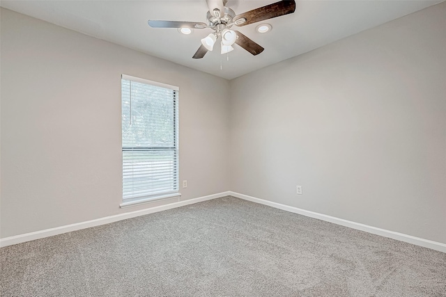 spare room with carpet and ceiling fan