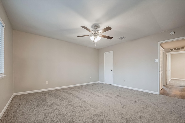 unfurnished room featuring ceiling fan and carpet floors