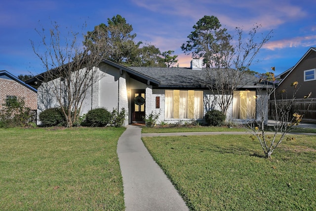 view of front of property with a yard