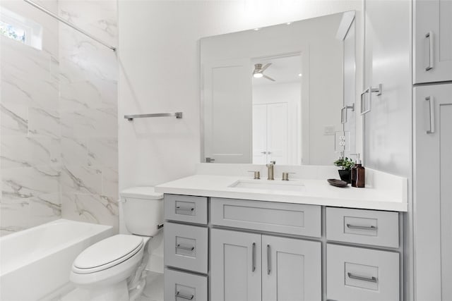 full bathroom with vanity, ceiling fan, toilet, and tiled shower / bath combo