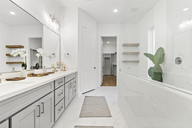 bathroom featuring vanity and a shower with door