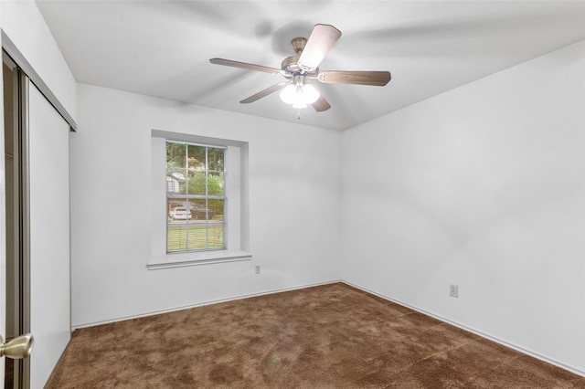 empty room featuring ceiling fan and carpet floors