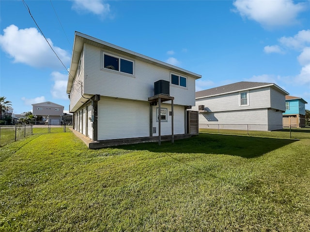 rear view of house featuring a yard