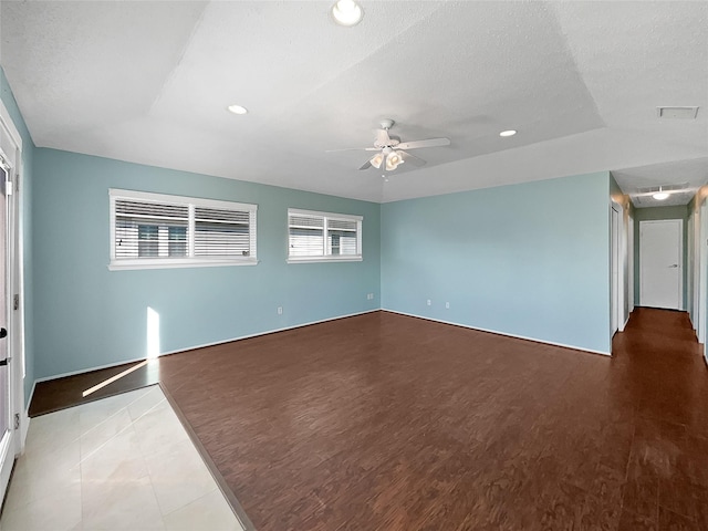 interior space with wood-type flooring, a textured ceiling, and ceiling fan