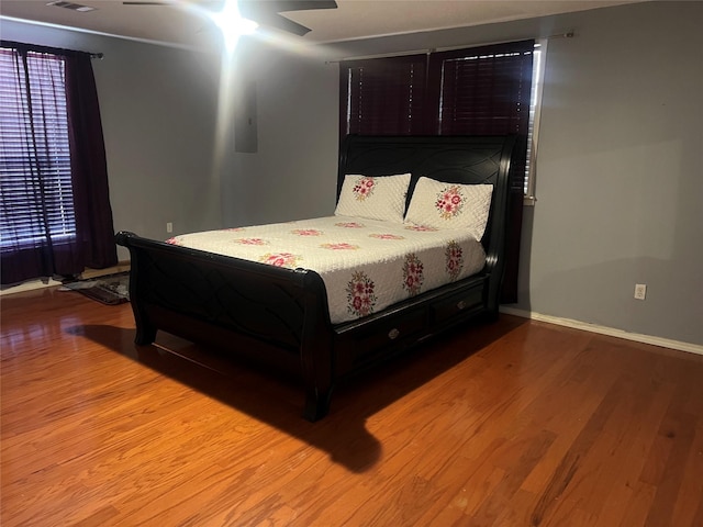 bedroom with wood-type flooring and ceiling fan