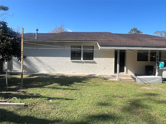 back of house with a yard