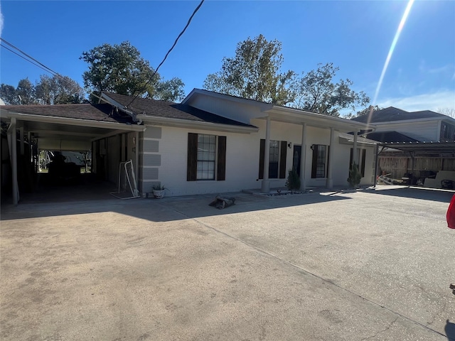 back of house featuring a carport