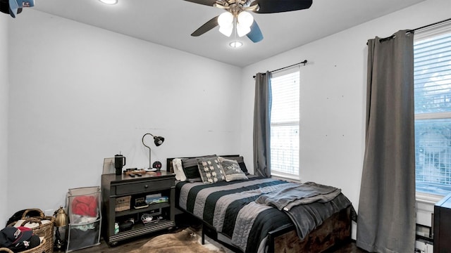 bedroom featuring multiple windows and ceiling fan