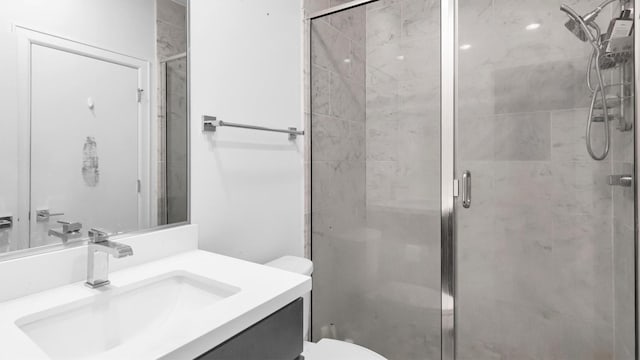 bathroom with vanity, toilet, and walk in shower