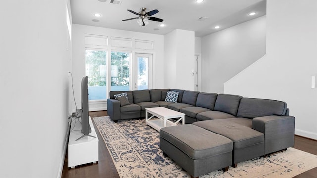 living room with ceiling fan and dark wood-type flooring