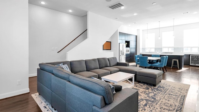 living room with dark hardwood / wood-style flooring and beverage cooler