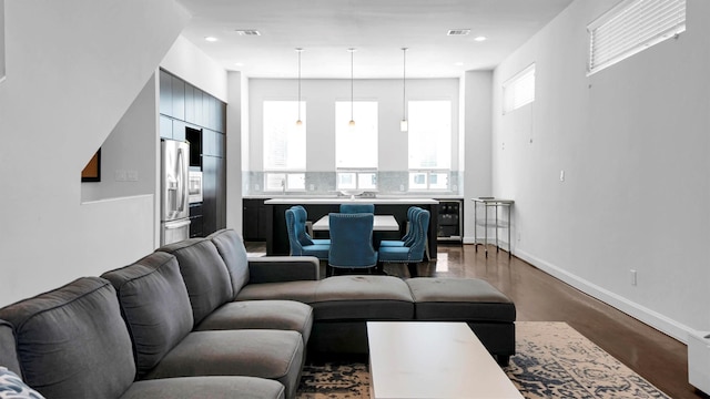 living room with hardwood / wood-style flooring, wine cooler, and a wealth of natural light