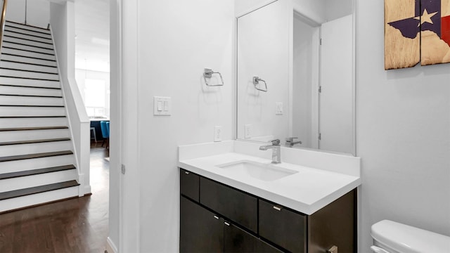 bathroom featuring hardwood / wood-style flooring, vanity, and toilet