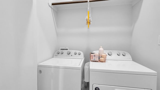 clothes washing area featuring washing machine and clothes dryer