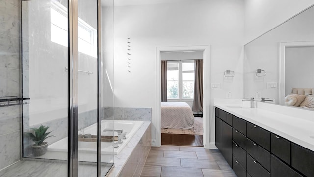 bathroom featuring vanity, wood-type flooring, and plus walk in shower