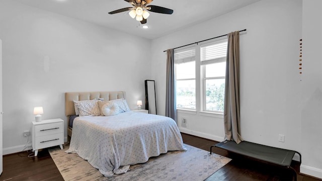 bedroom with ceiling fan and dark hardwood / wood-style floors