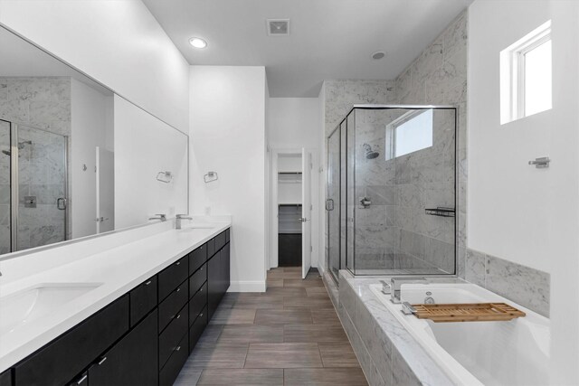 3111 Leeland St, Houston, TX 77003 - full bath with a bath, a stall shower, double vanity, a spacious closet, and baseboards