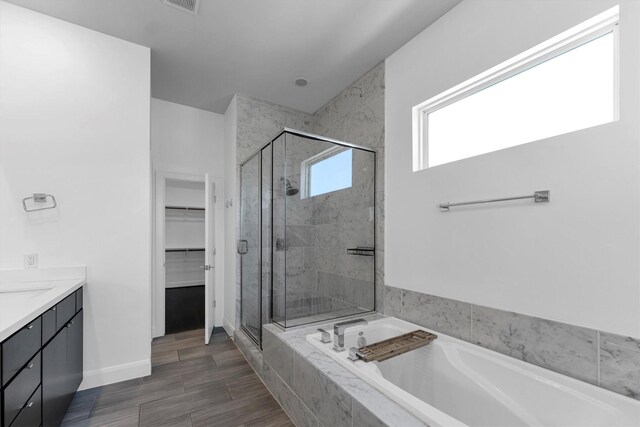 3111 Leeland St, Houston, TX 77003 - full bathroom with a bath, a stall shower, vanity, and a walk in closet
