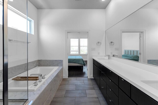 3111 Leeland St, Houston, TX 77003 - ensuite bathroom featuring a garden tub, healthy amount of natural light, and double vanity