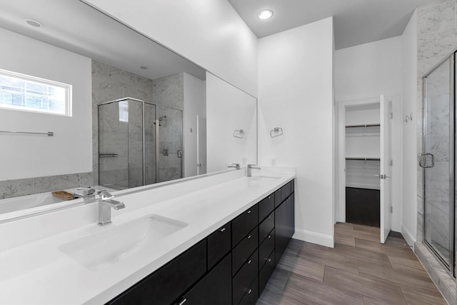 3111 Leeland St, Houston, TX 77003 - bathroom with a shower stall, double vanity, a walk in closet, baseboards, and recessed lighting