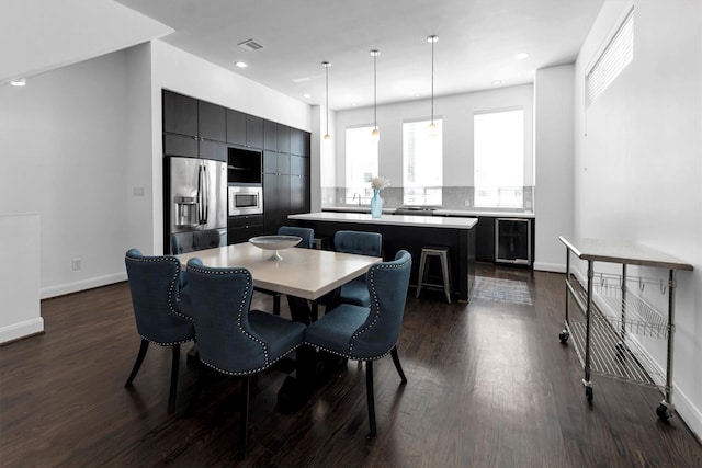 3111 Leeland St, Houston, TX 77003 - dining space with wine cooler, dark wood-style floors, baseboards, and recessed lighting