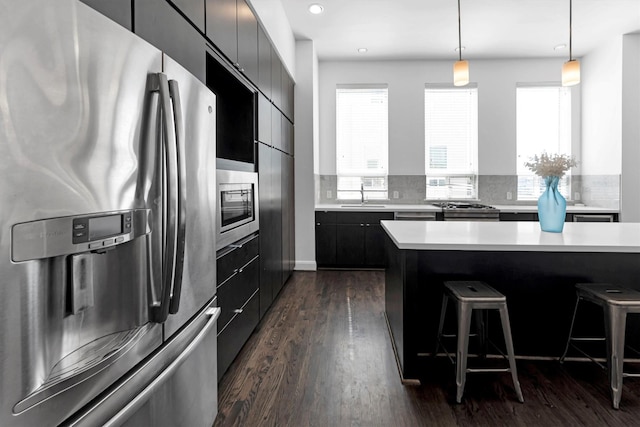 3111 Leeland St, Houston, TX 77003 - kitchen featuring stainless steel appliances, modern cabinets, a sink, a kitchen bar, and light countertops