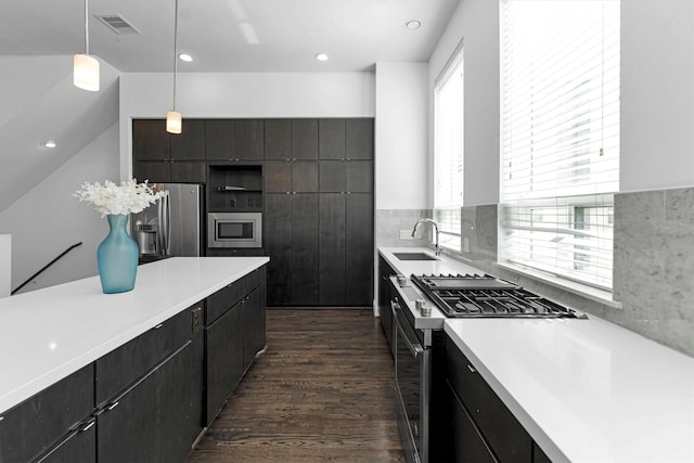 3111 Leeland St, Houston, TX 77003 - kitchen with appliances with stainless steel finishes, a sink, light countertops, dark wood-style flooring, and recessed lighting