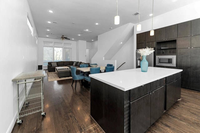 3111 Leeland St, Houston, TX 77003 - kitchen with appliances with stainless steel finishes, dark wood-style flooring, a center island, ceiling fan, and recessed lighting