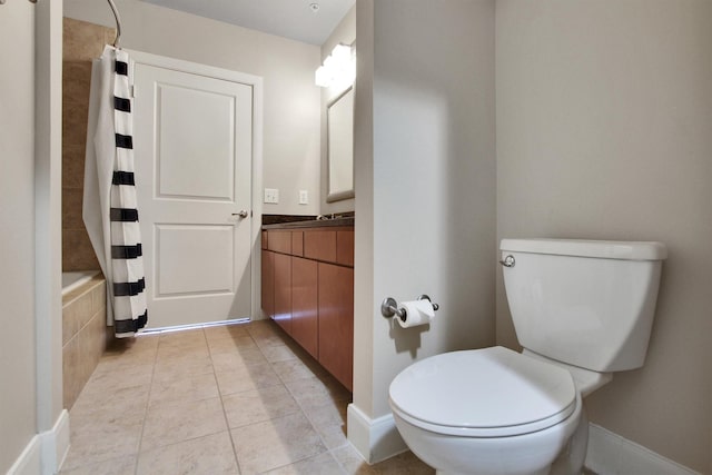300 St Joseph Pkwy Unit 318, Houston, TX 77002 - bathroom with toilet, vanity, tile patterned flooring, baseboards, and tiled shower / bath