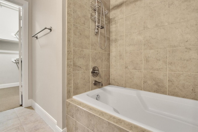 300 St Joseph Pkwy Unit 318, Houston, TX 77002 - bathroom with baseboards, tiled shower / bath, and tile patterned flooring