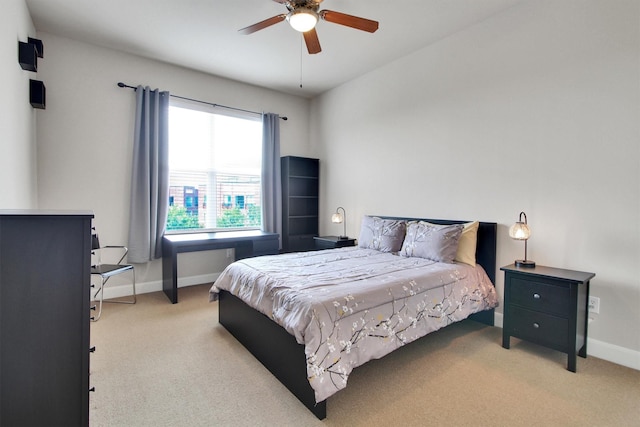 bedroom featuring ceiling fan and light carpet