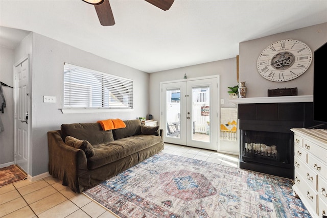 tiled living room featuring ceiling fan and french doors