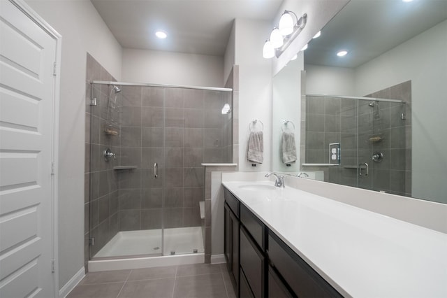 bathroom featuring tile patterned floors, vanity, and walk in shower