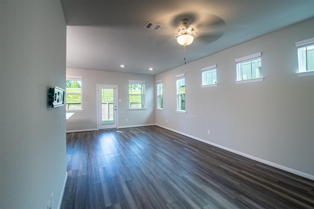 spare room with ceiling fan and dark hardwood / wood-style flooring