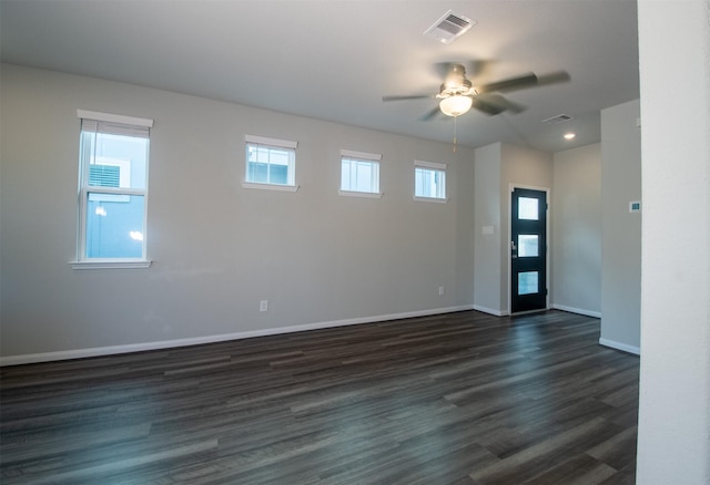 spare room featuring ceiling fan and dark wood-type flooring