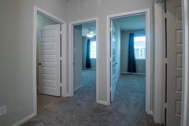 hallway featuring light colored carpet