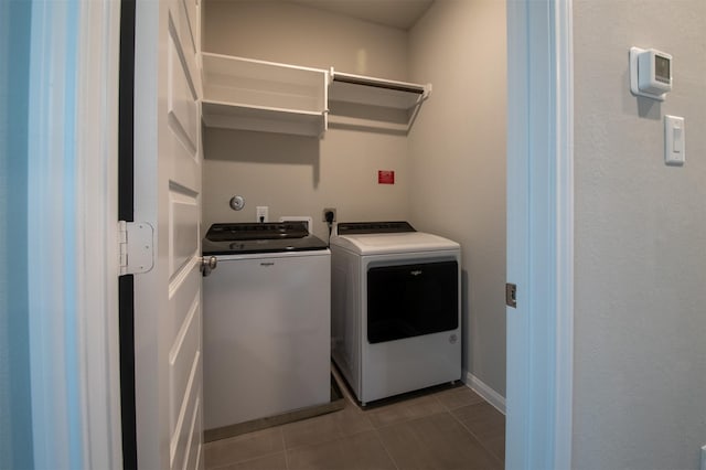 laundry area featuring light tile patterned flooring and separate washer and dryer