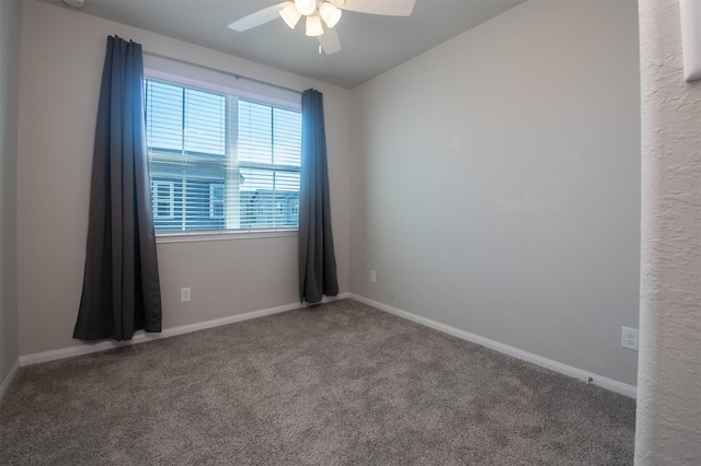 carpeted empty room featuring ceiling fan