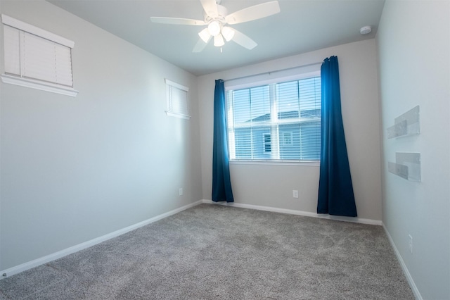 empty room featuring ceiling fan and light colored carpet