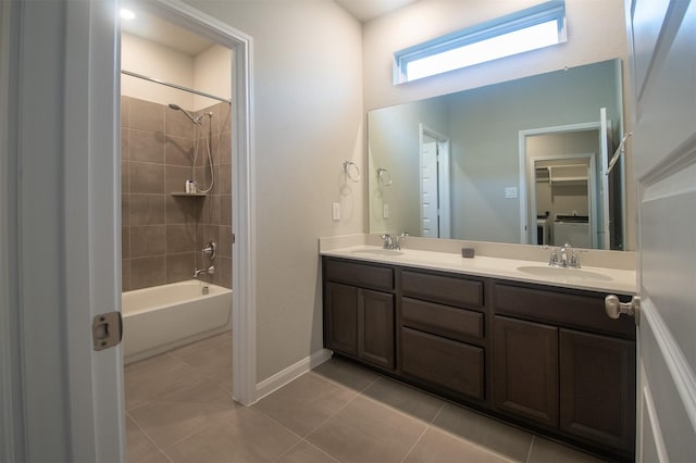 bathroom with tile patterned flooring, vanity, and tiled shower / bath combo