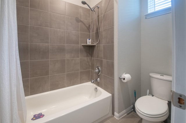 bathroom featuring tile patterned floors, shower / bath combination with curtain, and toilet