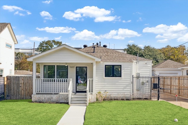 bungalow with a porch and a front yard