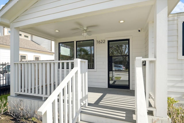 view of exterior entry with a porch and ceiling fan